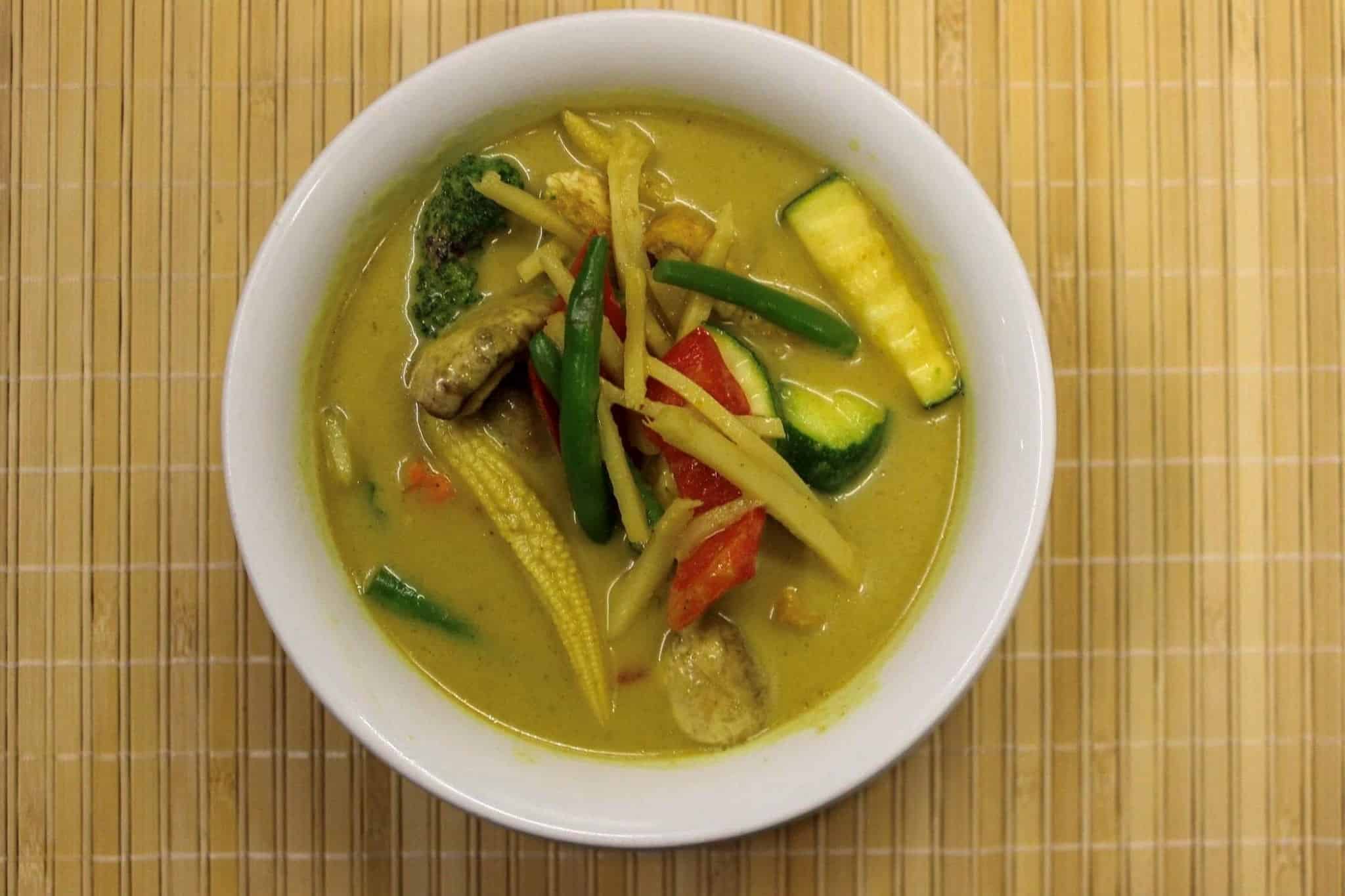 A Gluten Free Thai Yellow curry with coconut milk, onion and potato, or sweet potato in a decorative bowl.