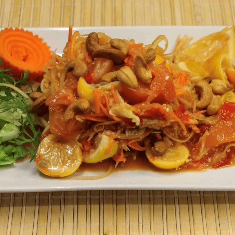 Fresh and fiery Papaya Salad (Som Tum) displayed on a plate.